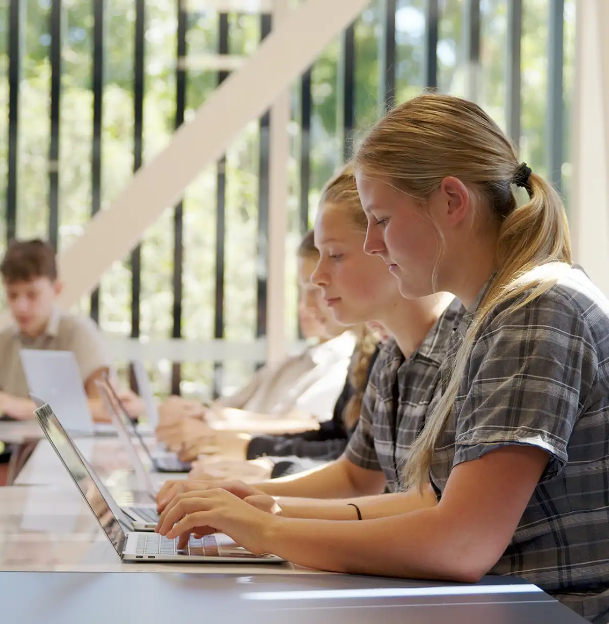 Student in a classroom using writers toolbox laptop